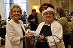 MWC Christmas in October Jerri Klein buys Basket of Cheer tickets from Melanie Rose MWC Christmas in October Jerri Klein buys Basket of Cheer tickets from Melanie Rose
