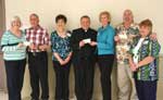 Presentation of $12,000 of grants to Ozanam Inn, Pennies for Bread and the New Orleans Mission (2009). From left, Linda Deichmann, sponsor of Ozanam Inn; Biaggio DiGiovanni representing Ozanam Inn;  Linda Sharp, Community Services chairman; Abbot Justin of St. Joseph's Abbey; Coleen Landry, MWC president and sponsor of Pennies for Bread and the Abbey; Ron Gonzales of the New Orleans Mission, and Mary Membreno, sponsor of New Orleans Mission.